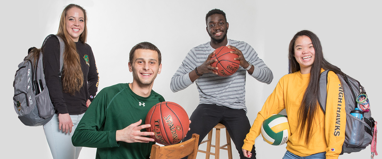 Students posing with sports equipment and uniforms