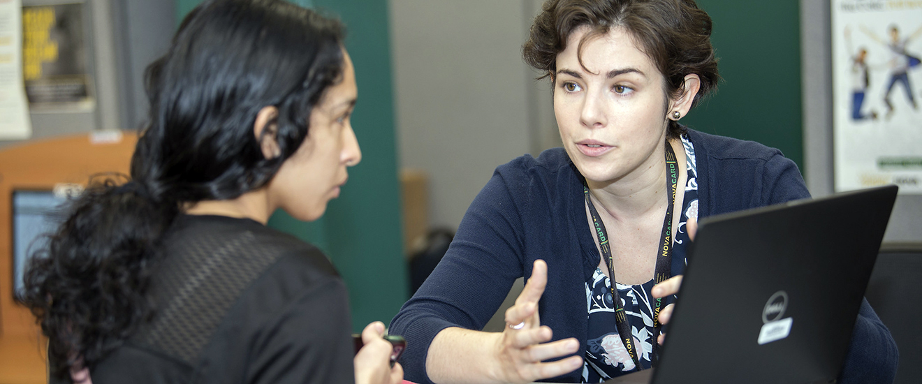 a student being helped by a staff member