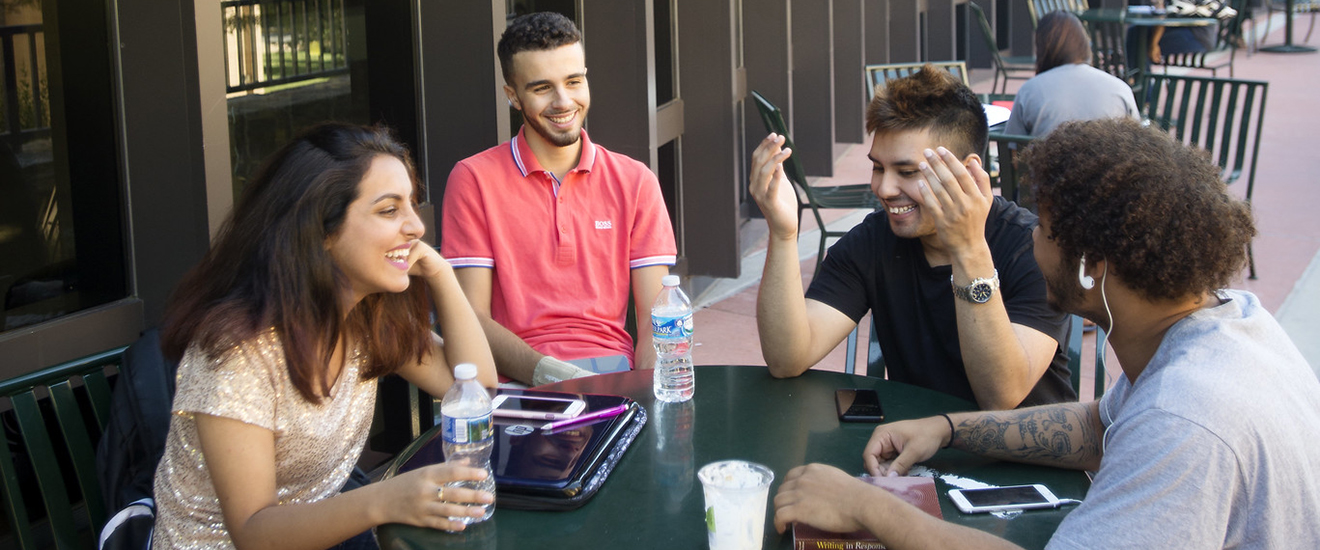 students sitting around a picnic table