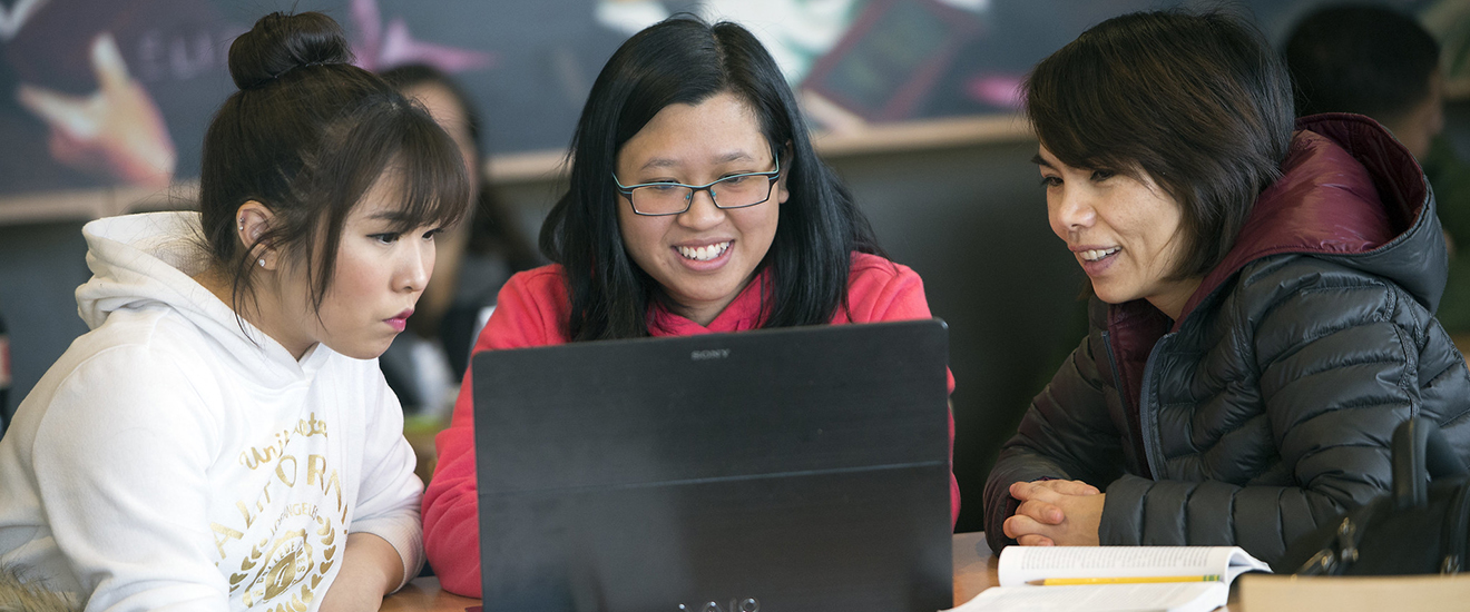 three students studying together