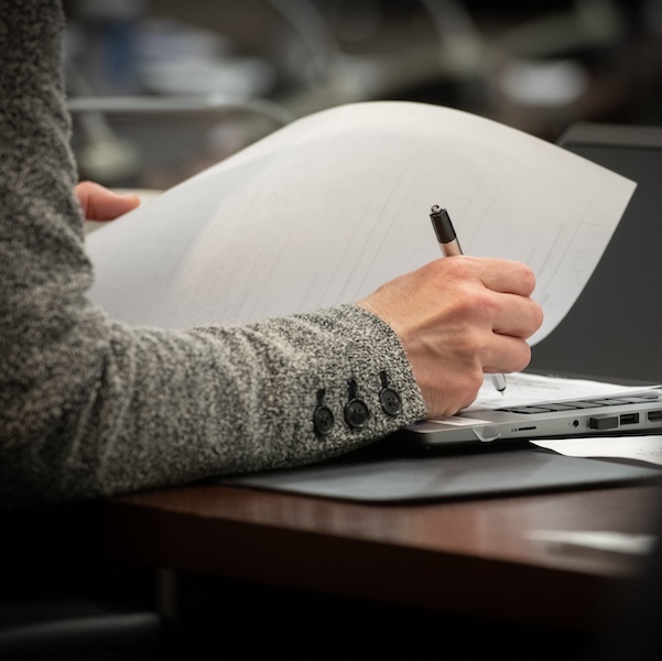 a woman writing on a piece of paper