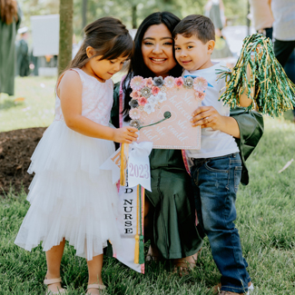 Yency Jovel stands with her children after her graduation