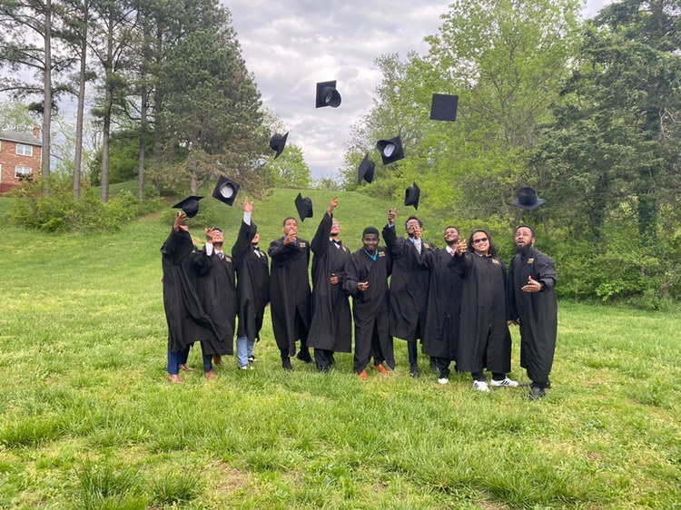 NOVA graduates tossing their caps in the air