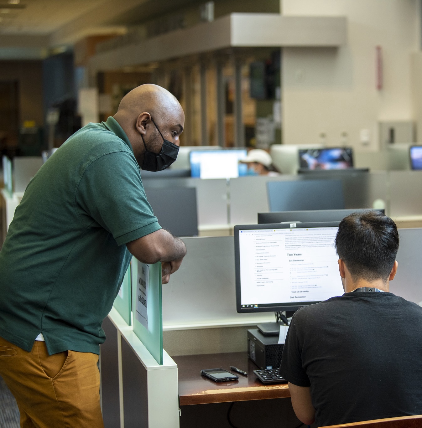 advisor helping out a student