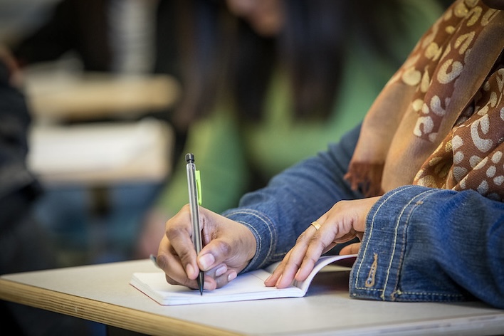 a student writing in a notebook