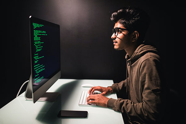 A student sitting at a computer screen that contains data