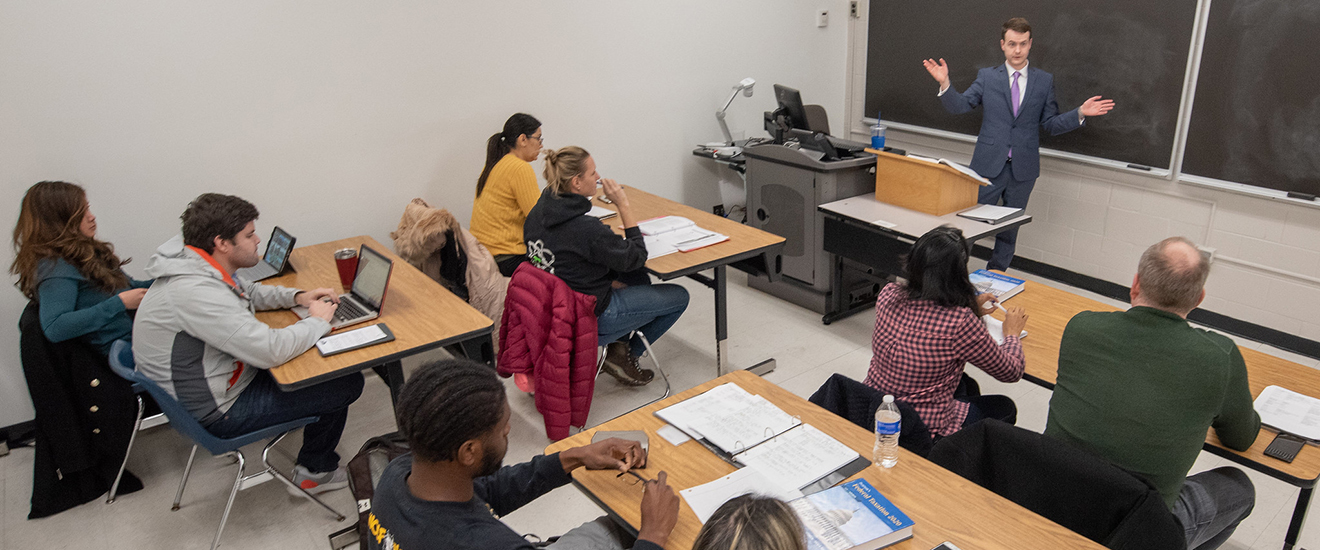 Students in the classroom listening to the instructors lecture