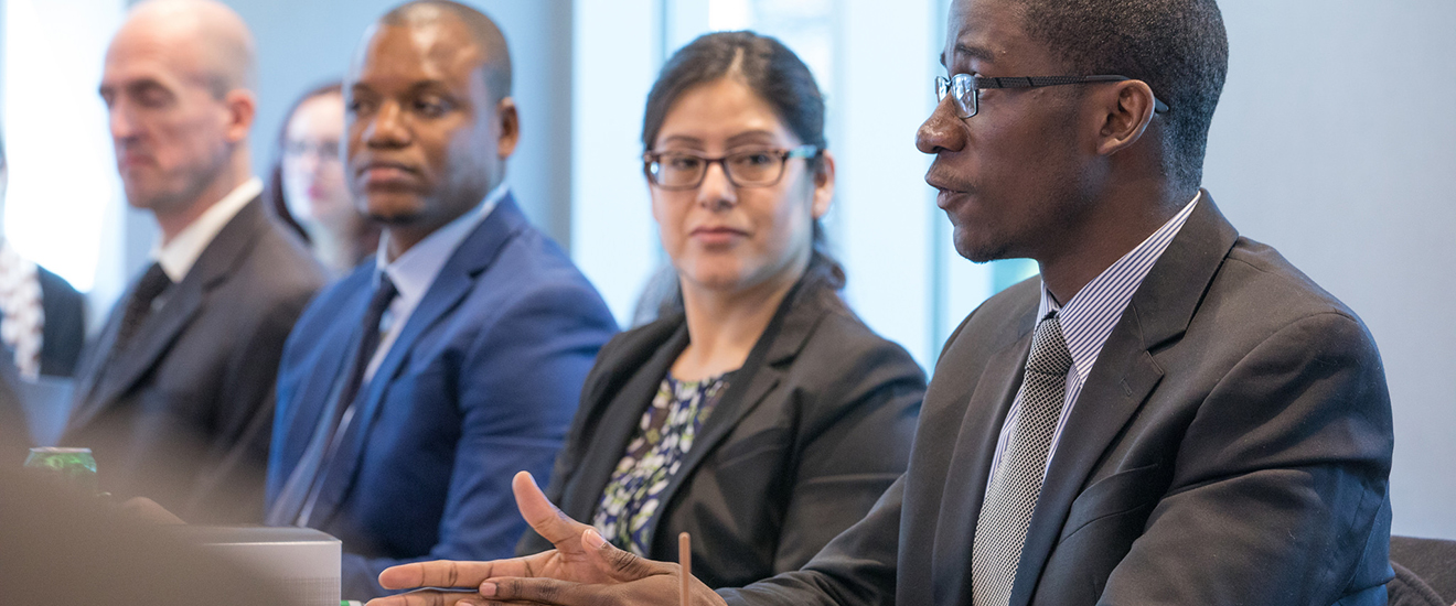 Students in a meeting wearing suits