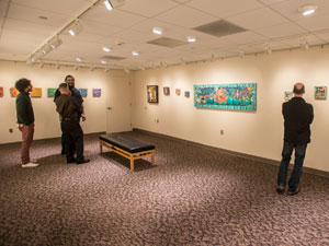 People looking at artwork at the Fisher Gallery