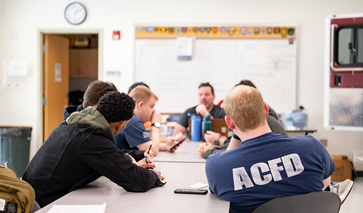 Group of staff gathered for an emergency preparedness training discussion.