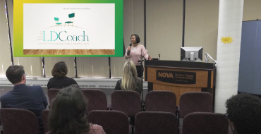 A person speaking at a podium in front of an audience