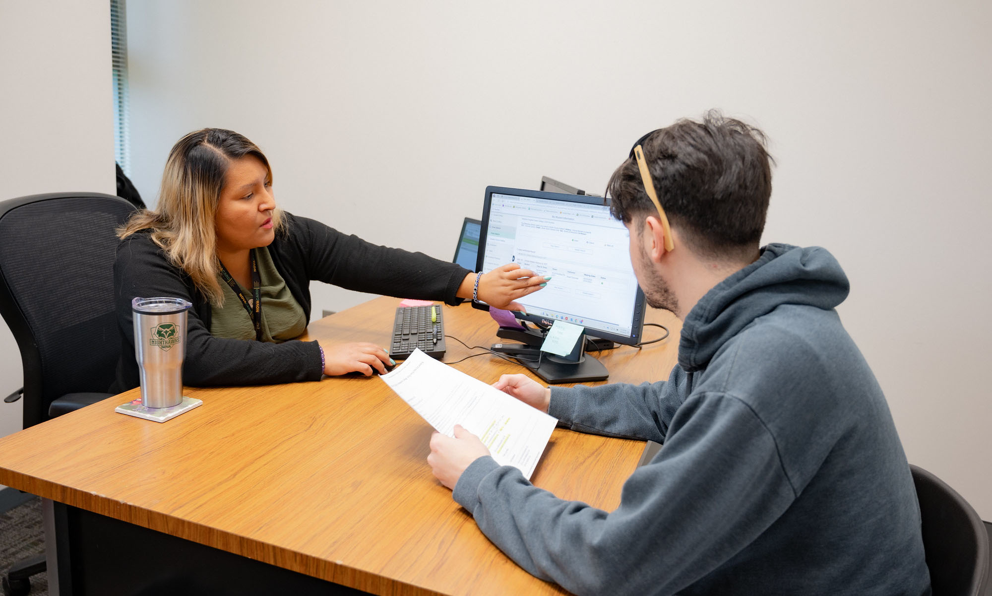 student meeting with an advisor at their office