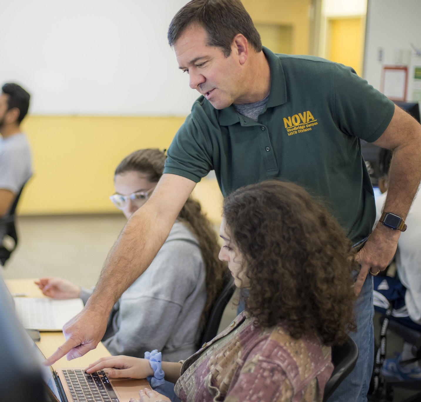 faculty member helping out a student